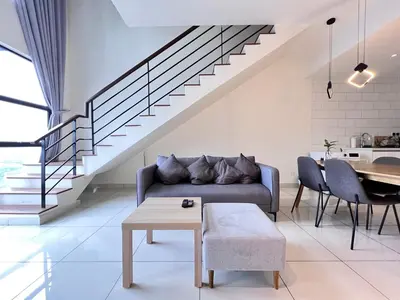 a living room with a couch and a table at Arte Mont Kiara By Comfortstay in Kuala Lumpur