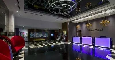 a lobby with a bar with purple lights on it at Oneiro D'Majestic place Klcc in Kuala Lumpur