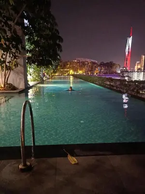 a large swimming pool at night in a city at TRION KL Family Residence at Kuala Lumpur in Kuala Lumpur