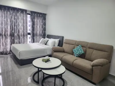a living room with a couch and a bed at TRION KL Family Residence at Kuala Lumpur in Kuala Lumpur