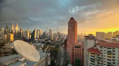 a view of a city skyline at sunset at AS Homes Kuala Lumpur in Kuala Lumpur