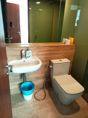 a bathroom with a toilet and a sink at Vortex Suites KLCC By Farysha in Kuala Lumpur