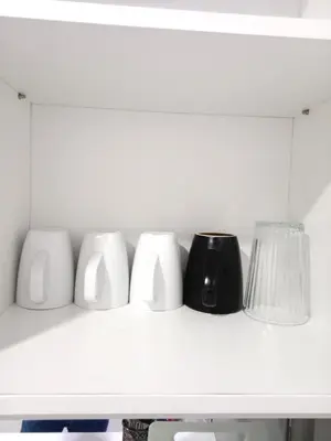 a shelf with four white vases and a lamp at Vortex Suites KLCC By Farysha in Kuala Lumpur