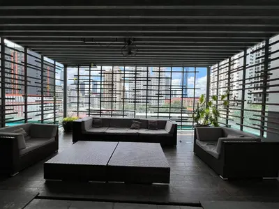 a living room with two couches and a large window at Nice & convenient Studio in KL in Kuala Lumpur