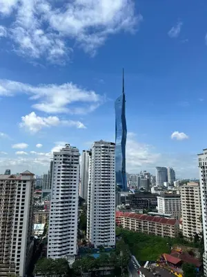 a city with a tall tower in the middle of buildings at Nice & convenient Studio in KL in Kuala Lumpur