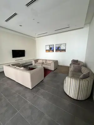 a living room with two couches and a flat screen tv at Nice & convenient Studio in KL in Kuala Lumpur