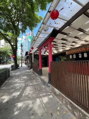 a building with red columns and awning on a sidewalk at Stylish Studio in ChangKat in Kuala Lumpur