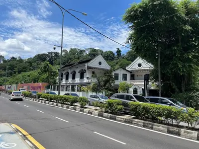 a street with cars parked in front of a house at Stylish Studio in ChangKat in Kuala Lumpur