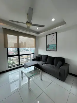 a living room with a couch and a glass table at Casa Residency in BBCC in Kuala Lumpur