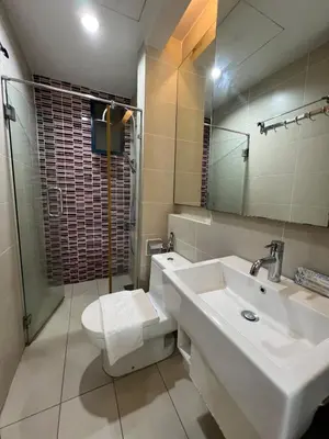 a bathroom with a sink and a toilet and a mirror at Casa Residency in BBCC in Kuala Lumpur