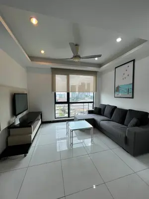 a living room with a couch and a tv at Casa Residency in BBCC in Kuala Lumpur