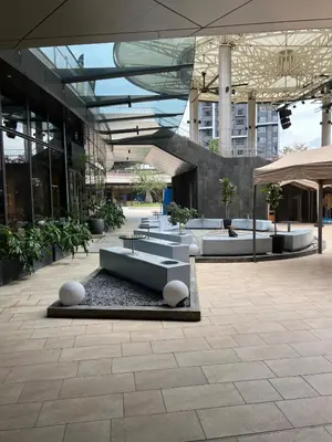a lobby of a building with tables and plants at Casa Residency in BBCC in Kuala Lumpur