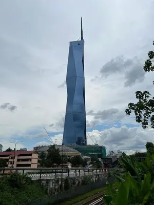 a tall blue building in the middle of a city at Casa Residency in Bukit in Kuala Lumpur