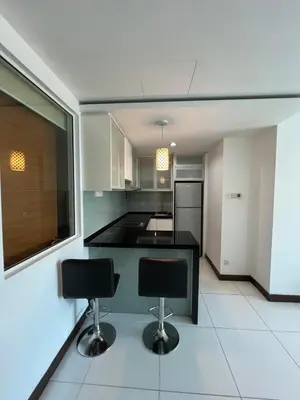 a kitchen with two bar stools in a room at Near Jalan Alor in Kuala Lumpur
