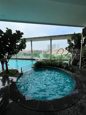 a large swimming pool with blue water in a building at Comfy place near Bukit in Kuala Lumpur