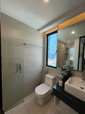 a bathroom with a toilet and a sink and a window at Comfy place near Bukit in Kuala Lumpur
