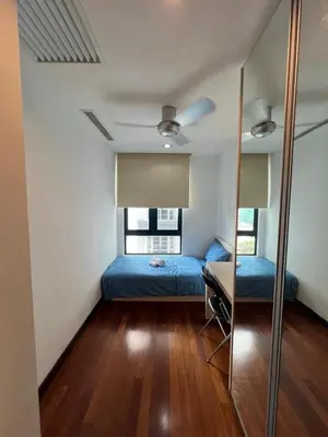 a bedroom with two beds and a desk in it at Spacious and Inviting casa Residence in Kuala Lumpur