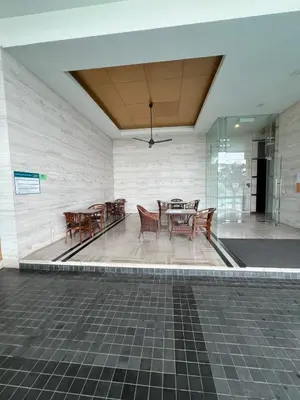 a dining area with tables and chairs in a building at Spacious and Inviting casa Residence in Kuala Lumpur