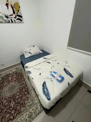 a bed with feathers on it in a room at Ayuanura Homestay in Kuala Lumpur
