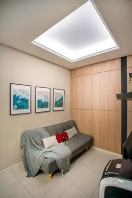 a living room with a couch with a large skylight at Dorsett Residences Sri Hartamas, Mont Kiara Kuala Lumpur in Kuala Lumpur
