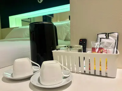 a table with two white dishes and a basket of cosmetics at Star Mews Hotel Changkat Bukit Bintang in Kuala Lumpur