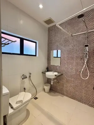 a bathroom with a shower and a toilet and a sink at Star Mews Hotel Changkat Bukit Bintang in Kuala Lumpur