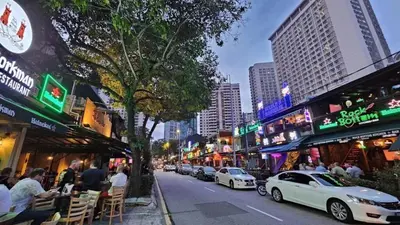 a city street with cars parked on the side of the road at Star Mews Hotel Changkat Bukit Bintang in Kuala Lumpur