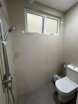 a bathroom with a toilet and two windows at Convenient KLCCAmpang Park Unit in Kuala Lumpur