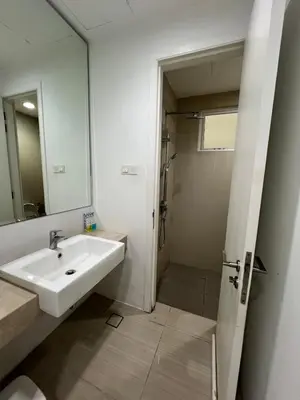 a white bathroom with a sink and a shower at Convenient KLCCAmpang Park Unit in Kuala Lumpur