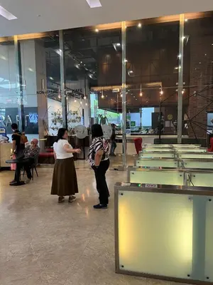 two women standing in front of a room with tables at Convenient KLCCAmpang Park Unit in Kuala Lumpur