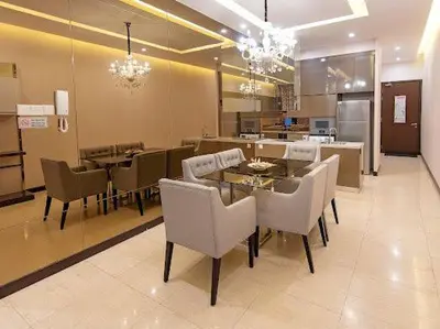 a dining room with a table and chairs and a kitchen at Dorsett Residence TRX KLCC #25 in Kuala Lumpur