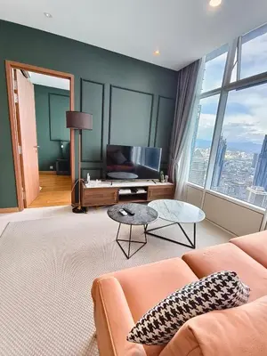 a living room with a couch and a table at Sky Suites KLCC Apartment by Family Room Stay in Kuala Lumpur