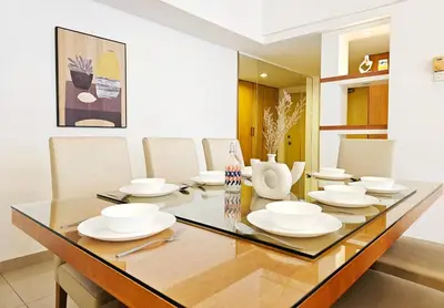 a dining room with a table with white dishes on it at Fahrenheit #185 Kuala Lumpur Bukit Bintang in Kuala Lumpur
