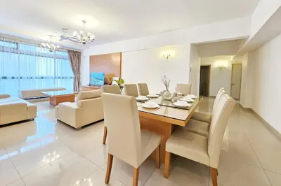 a dining room and living room with a table and chairs at Fahrenheit #185 Kuala Lumpur Bukit Bintang in Kuala Lumpur