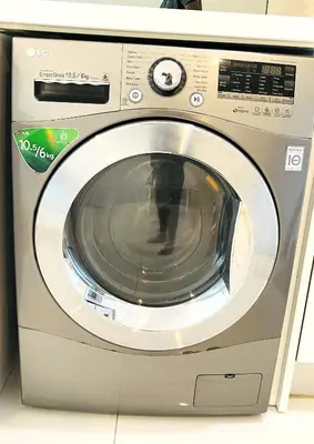 a silver washing machine sitting in a room at Summer Suites by Western Holiday in Kuala Lumpur