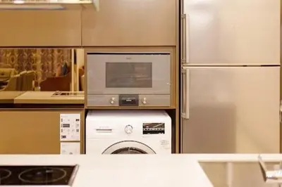 a kitchen with a washing machine and a refrigerator at Dorsett Residence #13 Kuala Lumpur Bukit Bintang TRX in Kuala Lumpur