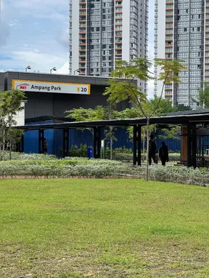 a building in a city with a tree in a park at Cosy 2-bedroom KLCC in Kuala Lumpur