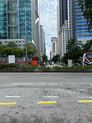 an empty street in a city with tall buildings at Great Value City Center Unit in Kuala Lumpur