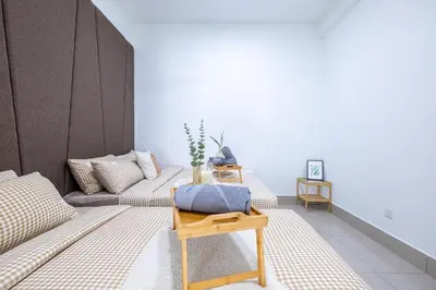 a living room with two beds and a table at RC Residence By Feel Home in Kuala Lumpur
