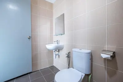 a bathroom with a toilet and a sink at RC Residence By Feel Home in Kuala Lumpur