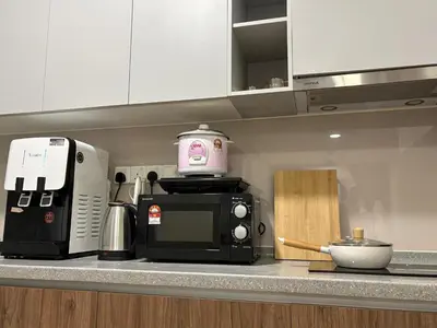a kitchen counter with a microwave and a coffee maker at Perfect for Families & Larger Groups, KL MRT- M Vertica in Kuala Lumpur