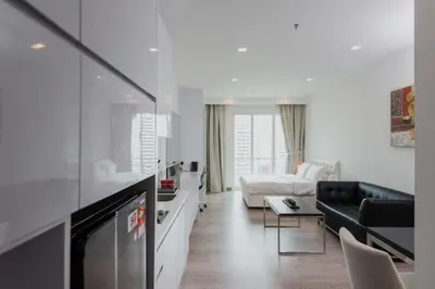 a white living room with a couch and a table at 1Bukit ceylon view 118 in Kuala Lumpur