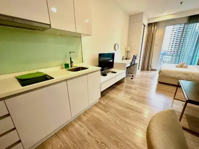 a room with a kitchen and a living room with a bed at 1Bukit ceylon view 118 in Kuala Lumpur