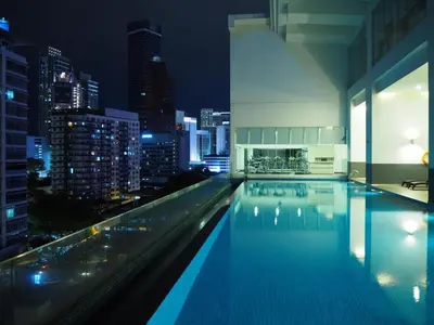 a swimming pool with a city skyline at night at 1Bukit ceylon view 118 in Kuala Lumpur