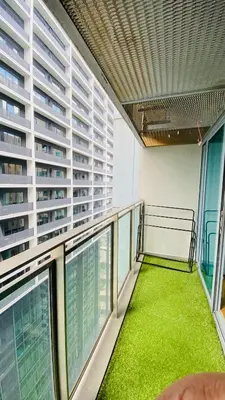 a balcony in a building with green grass on it at Mercu Summer Suites near KLCC in Kuala Lumpur