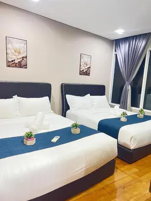 a room with two beds and two windows at Vortex Suites KLCC, 10 Pax - 3 Bedrooms Apartment in Kuala Lumpur