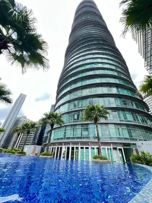 a swimming pool in front of a tall building at Vortex Suites KLCC, 10 Pax - 3 Bedrooms Apartment in Kuala Lumpur