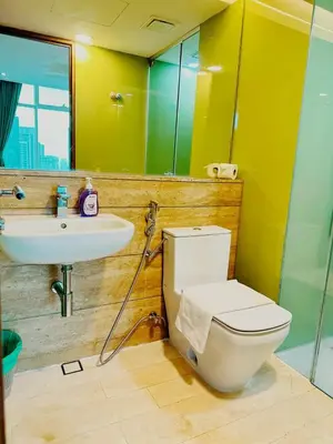 a bathroom with a white toilet and a sink at Vortex Suites KLCC, 10 Pax - 3 Bedrooms Apartment in Kuala Lumpur