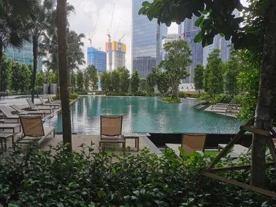 a pool of water with chairs in a city at AGILE Galaxy Suite in Kuala Lumpur