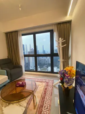 a living room with a view of a city at AGILE Galaxy Suite in Kuala Lumpur